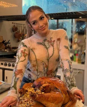 JLo poses with a large Turkey as she expresses gratitude
