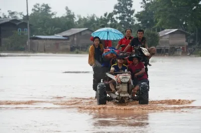What is causing the widespread flooding in Laos?