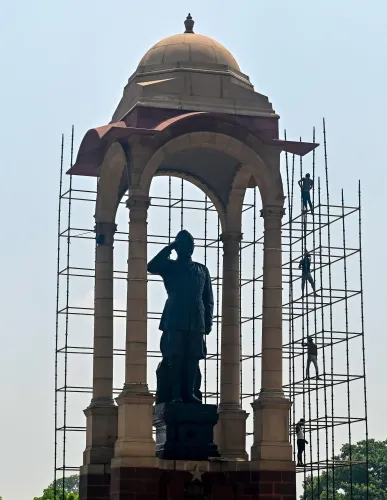 New Delhi: Workers clean Subhash Chandra Bose statue at India Gate