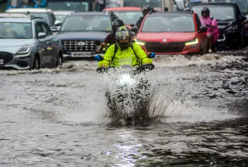 Kolkata: Commuters navigate waterlogged road after heavy rain