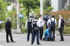 Why was a man arrested for stabbing two individuals in Fukuoka?