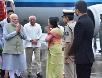 How was PM Modi welcomed at Gujarat airport for Sardar Patel's 150th birth anniversary celebrations?