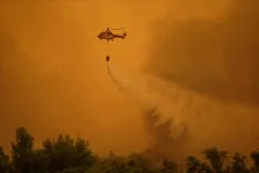 Two firefighting helicopters collide mid-air over Greece wildfire in Attica
