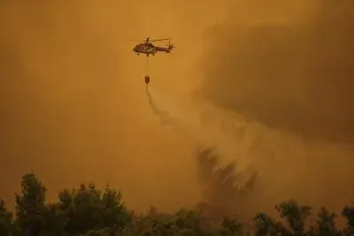 Two firefighting helicopters collide mid-air over Greece wildfire in Attica