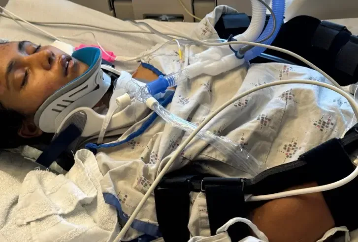 How is the Indian girl in a coma after a crash being supported by her community?